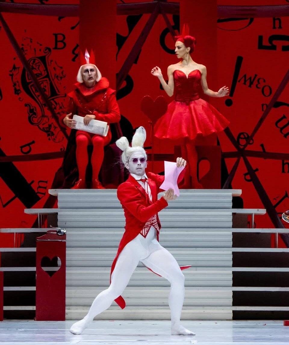 The White Rabbit portrayed by Stefan Goncalvez. Father/King of Hearts (played by David Gombert) and Mother/Queen of Hearts (played by Victoria Jaiani) shown in background. (Photo by Cheryl Mann)